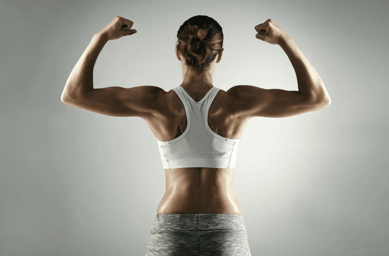 Woman turned around and flexing her muscles.